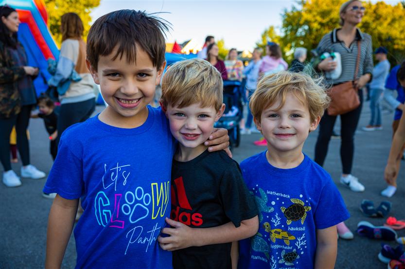 Three boys smile at the Pearre Creek Panther Party